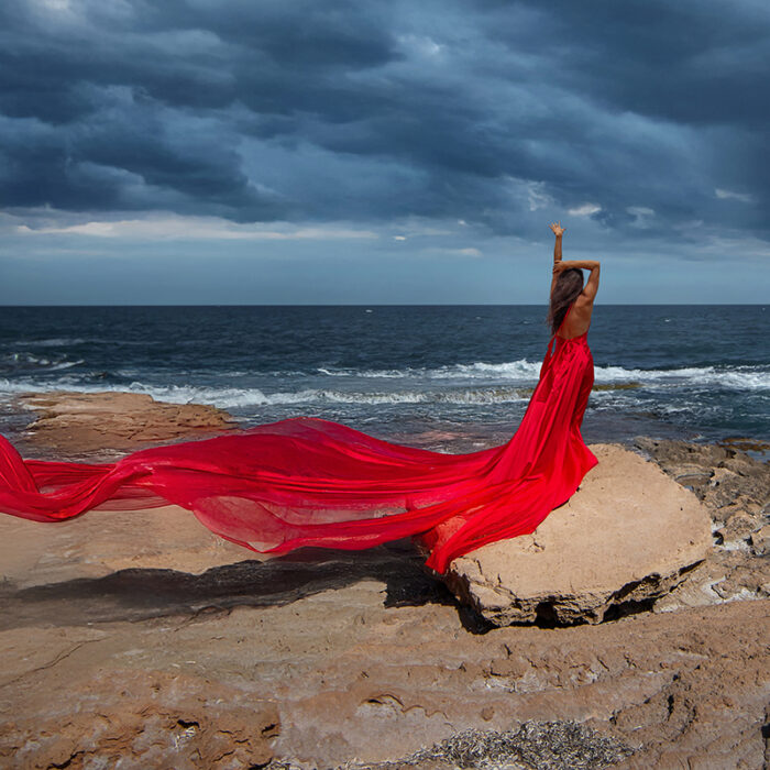 Goddess photoshoot at the beach in Torrevieja, Spain with Meliana Solara in a red dress.